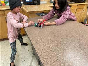 students discuss their design and try it out for the first time